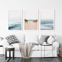 Load image into Gallery viewer, Beige Sandy Beach, Blue Ocean Waves, Surfers. Set of 3 Prints. White Frames
