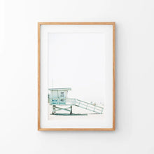 Load image into Gallery viewer, California Coastal Life Themed Print. Blue Lifeguard Hut. Thin Wood Frame with Mat
