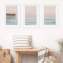 Load image into Gallery viewer, Ocean Sunset Photography with a Pier and Seagulls. Set of 3 Prints. White Frames with Mat
