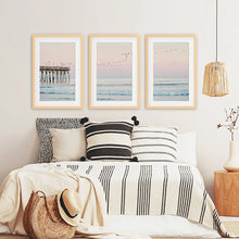 Load image into Gallery viewer, Ocean Sunset Photography with a Pier and Seagulls. Set of 3 Prints. Wood Frames with Mat
