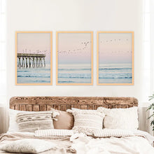 Load image into Gallery viewer, Ocean Sunset Photography with a Pier and Seagulls. Set of 3 Prints. Wood Frames
